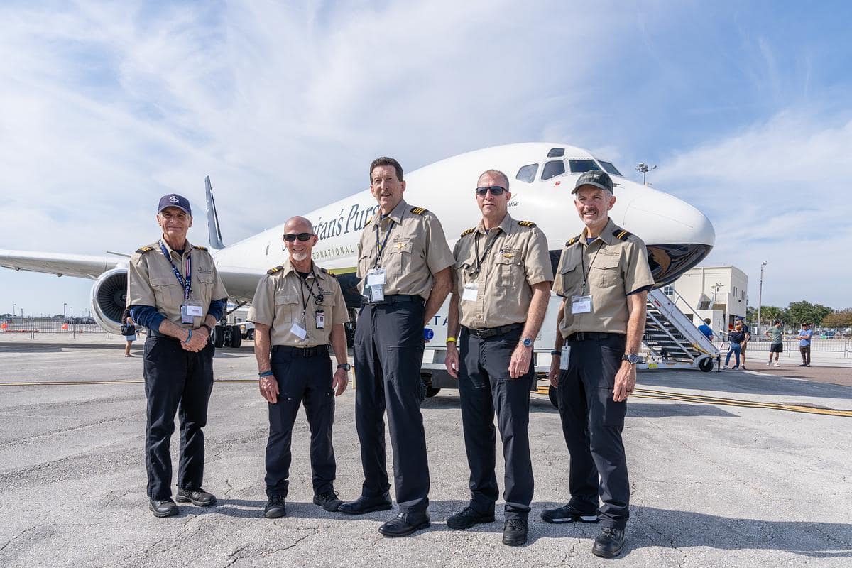 Embry-Riddle alumni who are crew members of the Samaritan’s Purse DC-8 stand in front of the plane, the last Douglas DC-8 registered in the United States.