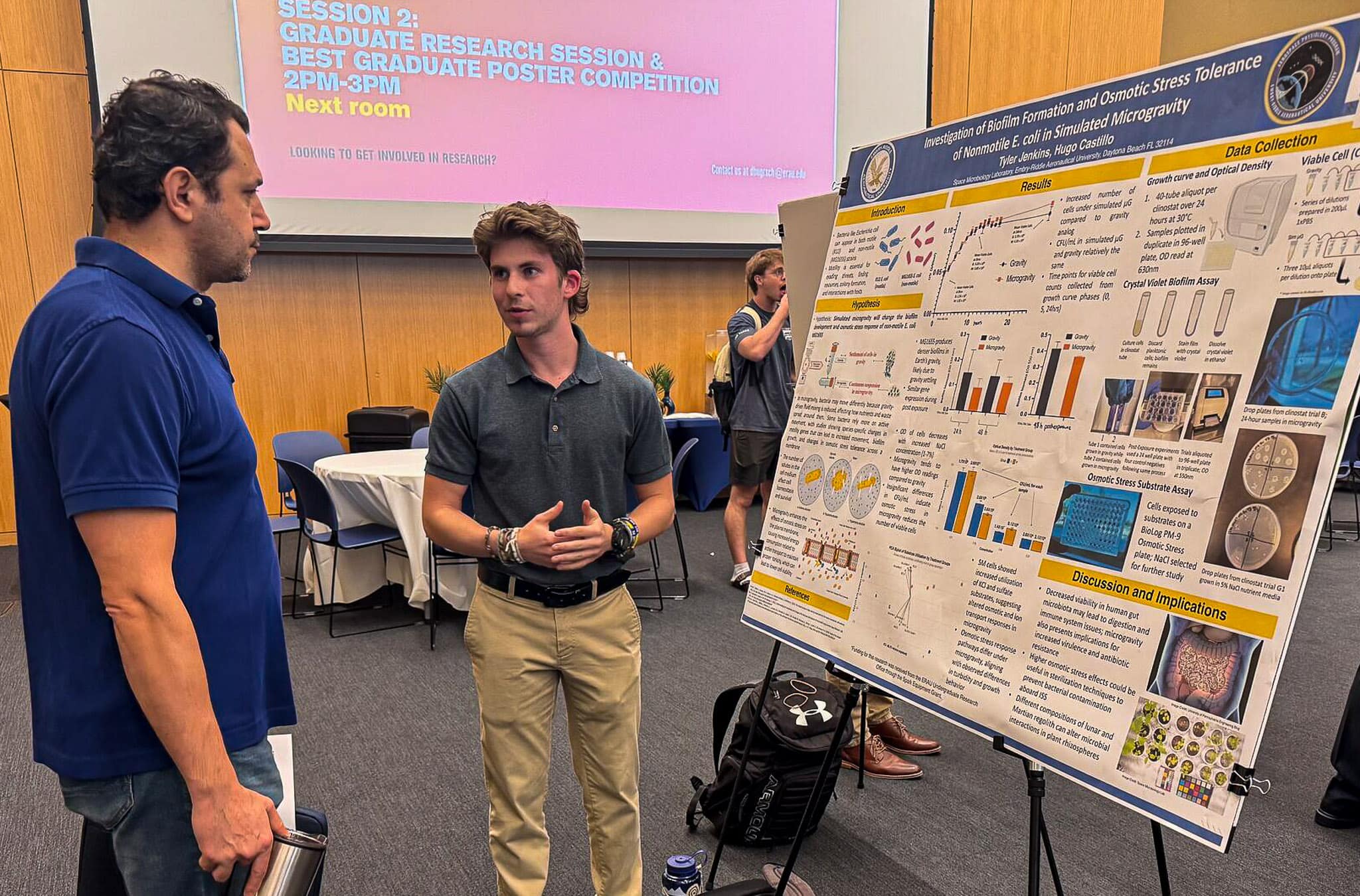 Tyler Jenkins, a sophomore Aerospace Physiology student, talks to an attendee about his research, which won the Best Overall Undergraduate Poster award at Embry-Riddle’s 2025 Student Research Symposium. His research examines how a specific strain of E. coli responds to microgravity.