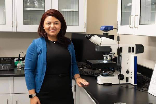 Dr. Marwa El-Sayed with a microscope