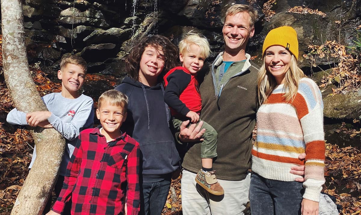 Family stands in the woods