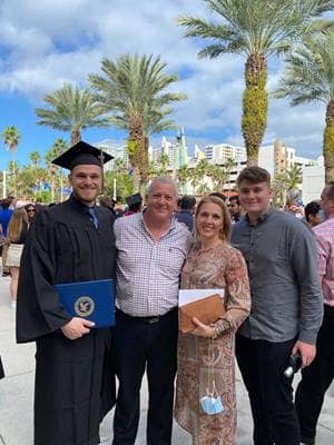 David Hughes (left) celebrates his 2021 graduation with dad John, mom Silvia and younger brother Christian.