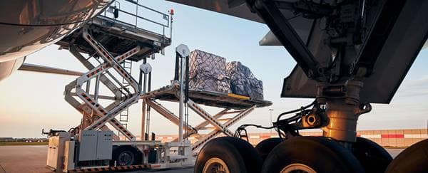 Cargo containers are loaded onto a plane