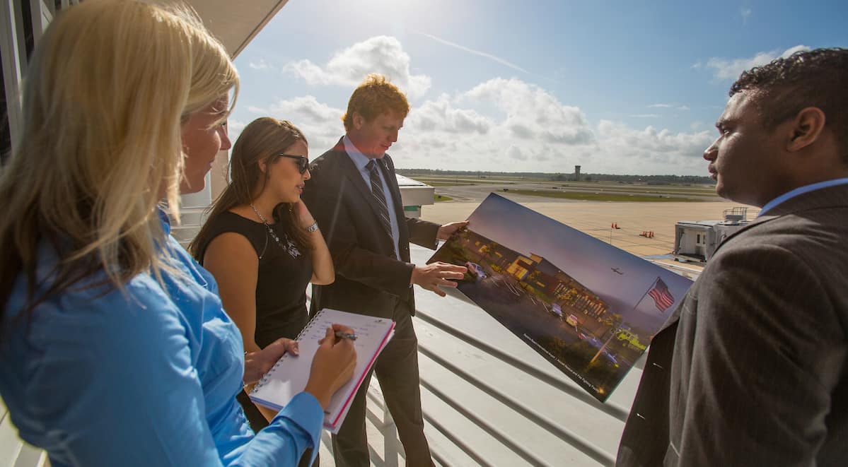 a group of people look at plans for a new building