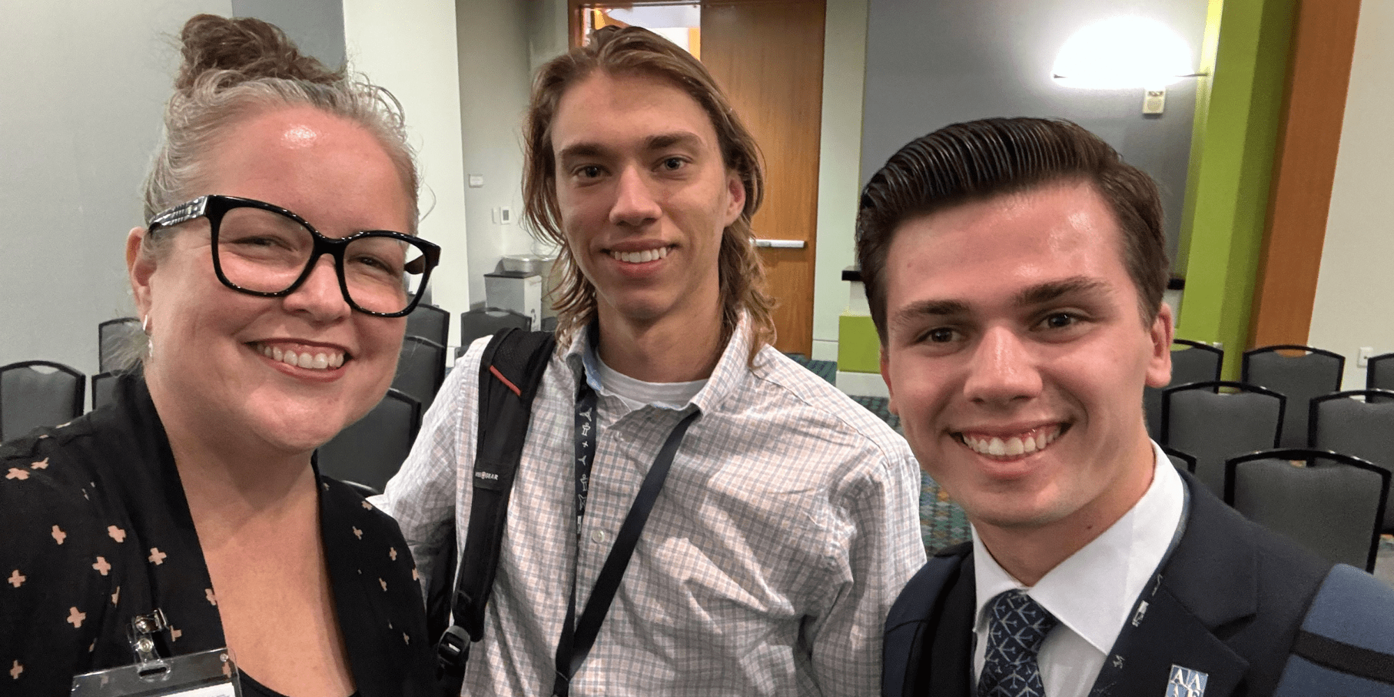 Kerri Haybittle-Raffel at the final dinner of the National Conference with Embry-Riddle students Jeswin Thomas (second from left) and Adam Zaraszczak (second from right).