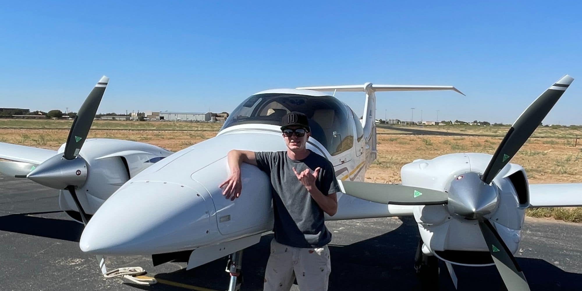 Brady Fredrickson in front of a Diamond DA42 Twin Star after earning his multi-engine rating.