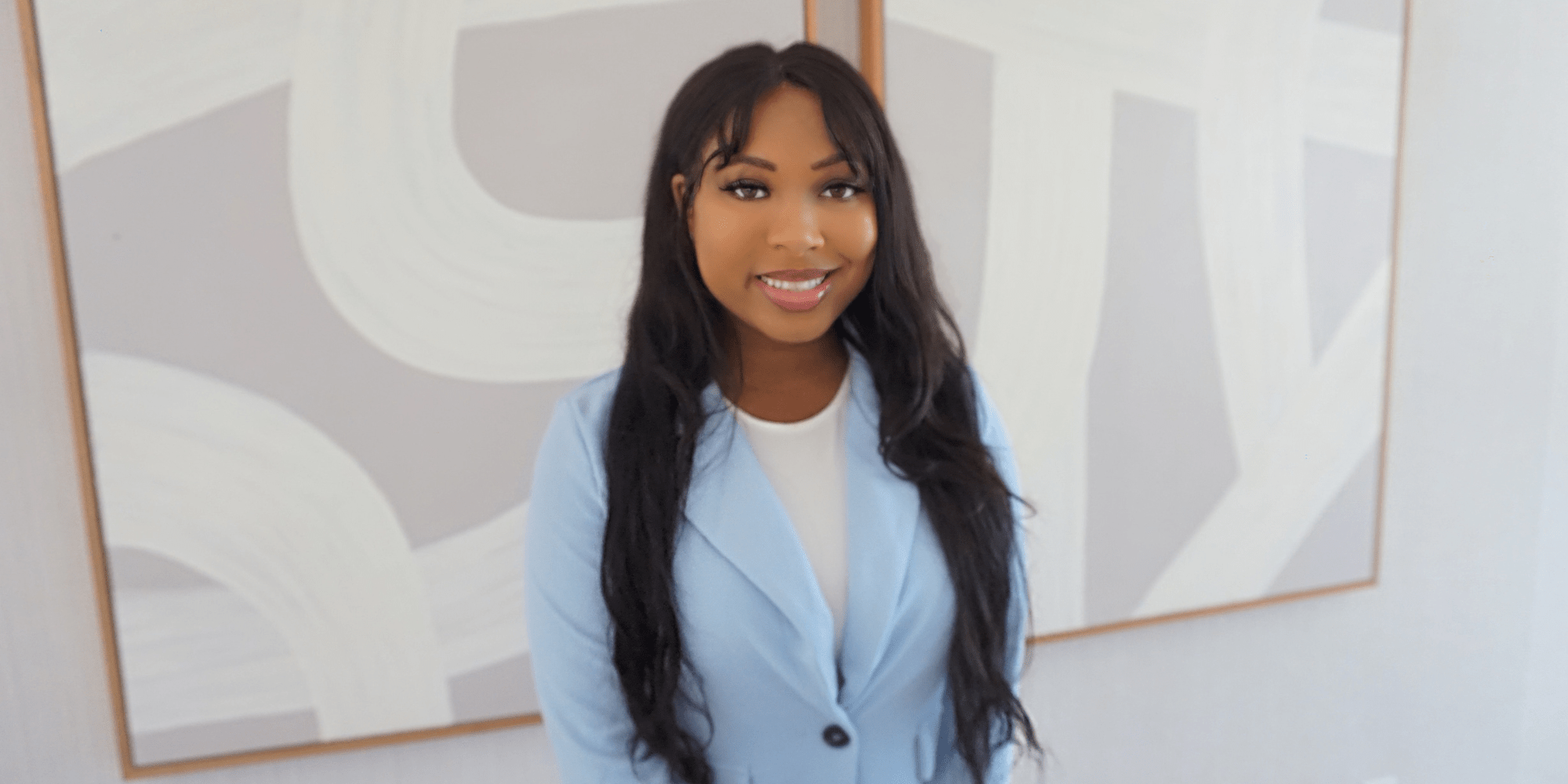 Christa Foster in a blue suit, professional headshot.