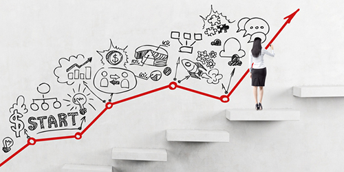 a woman sketches a plan for success