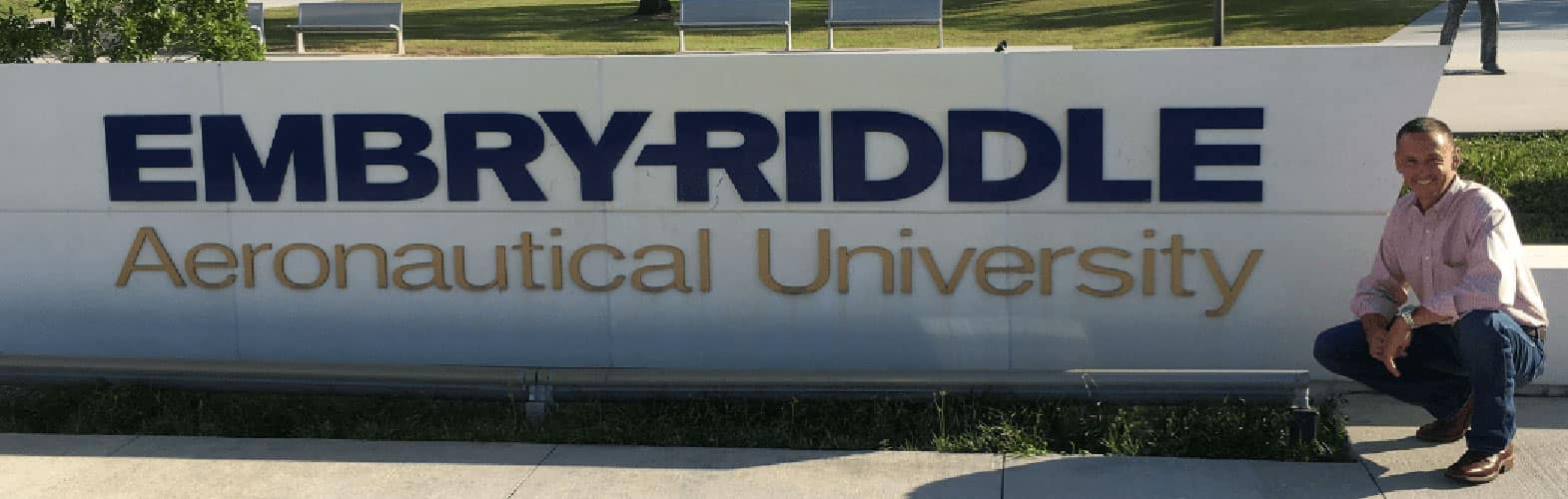 Chase Trissel in front of the Embry-Riddle sign