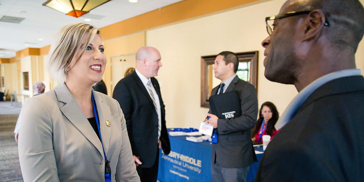 Graduates mingle with potential employers at the Worldwide Career Expo