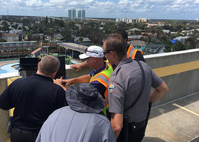 People on a condo roof with a drone.