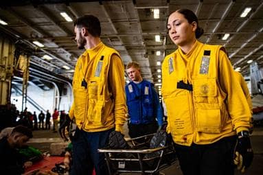 Sailors conduct stretcher bearer maneuvers during a mass casualty drill aboard the aircraft carrier USS Nimitz (CVN 68) in the Pacific Ocean