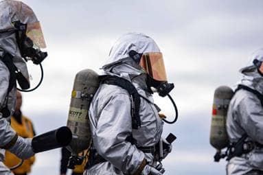 Sailors simulate fighting a fire during a mass casualty drill aboard the aircraft carrier USS Nimitz (CVN 68) in the Pacific Ocean