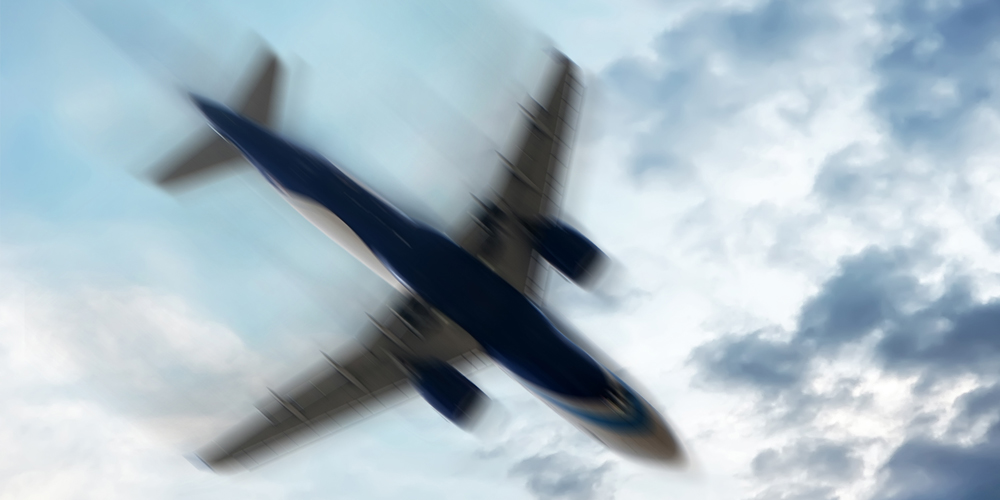 A commercial airplane flies overhead.